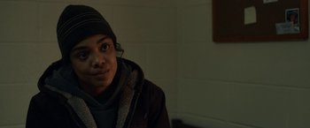 Movie still from “Little Woods” (2018), directed by Nia DaCosta – A man in a brown jacket and a black hat; Close Up shot, Over the shoulder angle