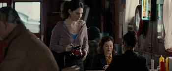 Movie still from “Little Woods” (2018), directed by Nia DaCosta – A woman holding a camera in front of another woman sitting down; Medium shot, Over the shoulder angle