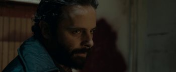 Movie still from “Little Woods” (2018), directed by Nia DaCosta – A person with a beard looking to his left; Close Up shot, Low angle