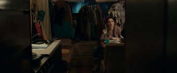 Movie still from “Little Woods” (2018), directed by Nia DaCosta – A woman sitting at a table in a room; Medium shot, Over the shoulder angle