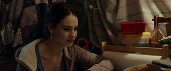 Movie still from “Little Woods” (2018), directed by Nia DaCosta – A woman sitting at a table looking at the camera; Close Up shot, Over the shoulder angle