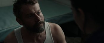 Movie still from “Little Woods” (2018), directed by Nia DaCosta – A person with a beard; Close Up shot, Over the shoulder angle
