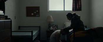 Movie still from “Little Woods” (2018), directed by Nia DaCosta – A man and a woman in a room with a bed and a lamp; Wide shot, High angle