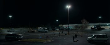 Movie still from “Little Woods” (2018), directed by Nia DaCosta – A parking lot at night with cars parked in it; Extreme Wide shot, High angle