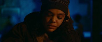 Movie still from “Little Woods” (2018), directed by Nia DaCosta – A person with a hat is looking down at the ground; Close Up shot, Low angle