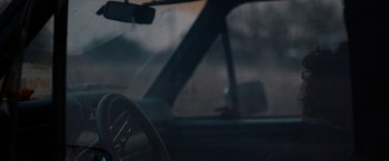 Movie still from “Little Woods” (2018), directed by Nia DaCosta – A view from inside a car of a dashboard and a steering wheel; Close Up shot, High angle