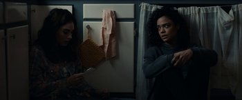 Movie still from “Little Woods” (2018), directed by Nia DaCosta – Two women are standing in a bathroom next to a door; Medium shot, Over the shoulder angle