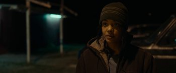 Movie still from “Little Woods” (2018), directed by Nia DaCosta – A young woman wearing a hat and a jacket; Close Up shot, Over the shoulder angle