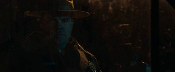 Movie still from “Little Woods” (2018), directed by Nia DaCosta – A man in a yellow hat is in the dark; Close Up shot, Low angle