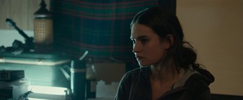 Movie still from “Little Woods” (2018), directed by Nia DaCosta – A young woman is sitting in front of a window; Close Up shot, Over the shoulder angle
