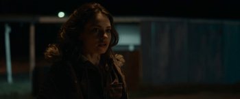 Movie still from “Little Woods” (2018), directed by Nia DaCosta – A woman in a brown jacket looking to her left; Close Up shot, Over the shoulder angle