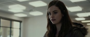 Movie still from “Little Woods” (2018), directed by Nia DaCosta – A woman with long brown hair standing in a room; Close Up shot, Over the shoulder angle