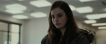 Movie still from “Little Woods” (2018), directed by Nia DaCosta – A woman with long brown hair standing in a room; Close Up shot, Over the shoulder angle