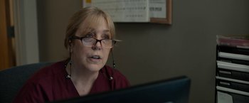 Movie still from “Little Woods” (2018), directed by Nia DaCosta – A woman wearing glasses looking at a computer screen; Close Up shot, Over the shoulder angle