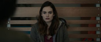 Movie still from “Little Woods” (2018), directed by Nia DaCosta – A young woman sitting on top of a wooden bench; Close Up shot, Over the shoulder angle