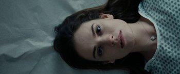 Movie still from “Little Woods” (2018), directed by Nia DaCosta – A person laying on a bed; Close Up shot, Overhead angle