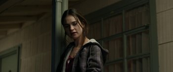 Movie still from “Little Woods” (2018), directed by Nia DaCosta – A young woman standing in front of a window; Medium shot, Over the shoulder angle