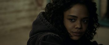 Movie still from “Little Woods” (2018), directed by Nia DaCosta – A person wearing a hooded jacket; Close Up shot, Over the shoulder angle