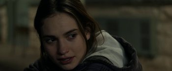 Movie still from “Little Woods” (2018), directed by Nia DaCosta – A person sitting down with her eyes closed; Close Up shot, Over the shoulder angle