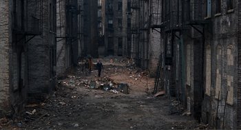 Movie still from “Live and Let Die” (1973), directed by Guy Hamilton – A couple of people walking down an alleyway; Extreme Wide shot, High angle