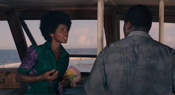 Movie still from “Live and Let Die” (1973), directed by Guy Hamilton – A woman talking to a man in front of the ocean; Medium shot, Over the shoulder angle