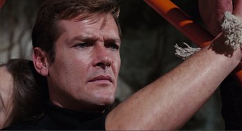 Movie still from “Live and Let Die” (1973), directed by Guy Hamilton – A person holding a baseball bat; Close Up shot, Low angle