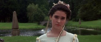 Movie still from “Labyrinth” (1986), directed by Jim Henson – A young woman in a white dress with flowers in her hair; Close Up shot, Over the shoulder angle
