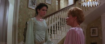 Movie still from “Labyrinth” (1986), directed by Jim Henson – Two women are standing in front of a staircase; Medium shot, Over the shoulder angle