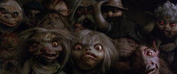 Movie still from “Labyrinth” (1986), directed by Jim Henson – A bunch of creepy looking dolls are in a pile; Close Up shot, High angle