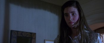 Movie still from “Labyrinth” (1986), directed by Jim Henson – A young woman with long dark hair looking at the camera; Close Up shot, Over the shoulder angle