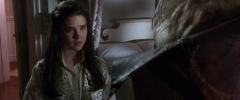 Movie still from “Labyrinth” (1986), directed by Jim Henson – A young woman in a white shirt is looking at a bed; Close Up shot, Over the shoulder angle