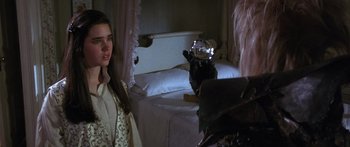 Movie still from “Labyrinth” (1986), directed by Jim Henson – A woman standing in front of a bed with a cat on top of it; Close Up shot, Over the shoulder angle