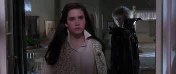 Movie still from “Labyrinth” (1986), directed by Jim Henson – A young woman standing next to a man in a room; Medium shot, Over the shoulder angle