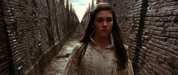 Movie still from “Labyrinth” (1986), directed by Jim Henson – A young woman standing in an alleyway; Close Up shot, Over the shoulder angle