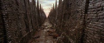 Movie still from “Labyrinth” (1986), directed by Jim Henson – An alley way between a row of trees in a wooded area; Extreme Wide shot, High angle