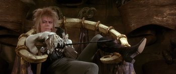 Movie still from “Labyrinth” (1986), directed by Jim Henson – A woman sitting on top of a tree branch; Medium shot, Low angle