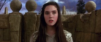 Movie still from “Labyrinth” (1986), directed by Jim Henson – A young woman with long dark brown hair and blue eyes; Close Up shot, High angle