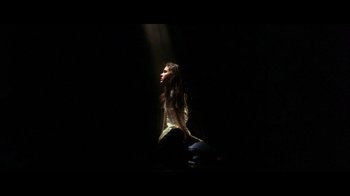 Movie still from “Labyrinth” (1986), directed by Jim Henson – A woman sitting on the ground in a dark room; Medium shot, Low angle