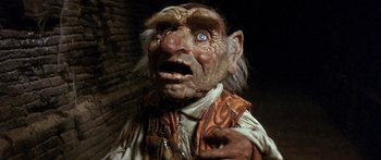 Movie still from “Labyrinth” (1986), directed by Jim Henson – An old man with blue eyes is looking at the camera; Close Up shot, Low angle