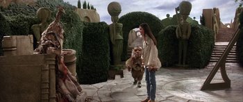 Movie still from “Labyrinth” (1986), directed by Jim Henson – A woman and a child are walking in a garden; Wide shot, Over the shoulder angle
