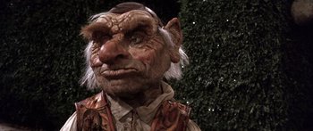 Movie still from “Labyrinth” (1986), directed by Jim Henson – An old man with a beard is wearing a hat; Close Up shot, Low angle