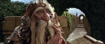 Movie still from “Labyrinth” (1986), directed by Jim Henson – An old man with long white hair and a long beard; Close Up shot, Low angle