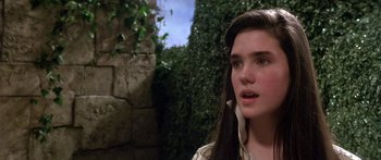 Movie still from “Labyrinth” (1986), directed by Jim Henson – A young woman with long black hair looking at the camera; Close Up shot, High angle