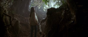 Movie still from “Labyrinth” (1986), directed by Jim Henson – A woman standing in the woods holding a stick; Wide shot, Low angle
