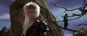 Movie still from “Labyrinth” (1986), directed by Jim Henson – David bowie as jareth the goblin king in the movie labyrinth; Medium shot, Low angle