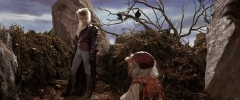 Movie still from “Labyrinth” (1986), directed by Jim Henson – A scene from the movie labyrinth with david bowie as jareth; Wide shot, Over the shoulder angle