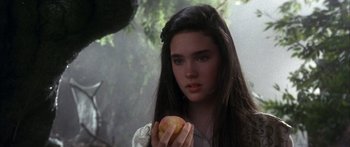 Movie still from “Labyrinth” (1986), directed by Jim Henson – A young woman holding an apple in her hands; Close Up shot, Over the shoulder angle