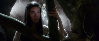 Movie still from “Labyrinth” (1986), directed by Jim Henson – A young woman leaning up against a tree in a forest; Close Up shot, Low angle