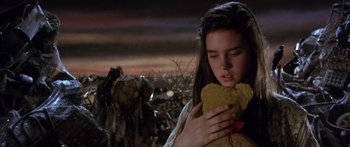 Movie still from “Labyrinth” (1986), directed by Jim Henson – A young girl holding a teddy bear in her hands; Close Up shot, High angle