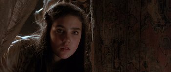 Movie still from “Labyrinth” (1986), directed by Jim Henson – A young girl is looking at the camera; Close Up shot, Low angle